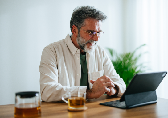 Person engaging with content on a tablet at a desk.