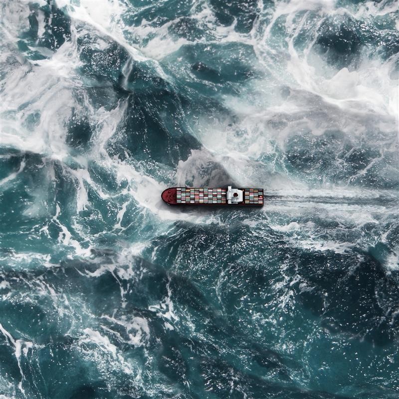 Large ship travelling in rough seas.