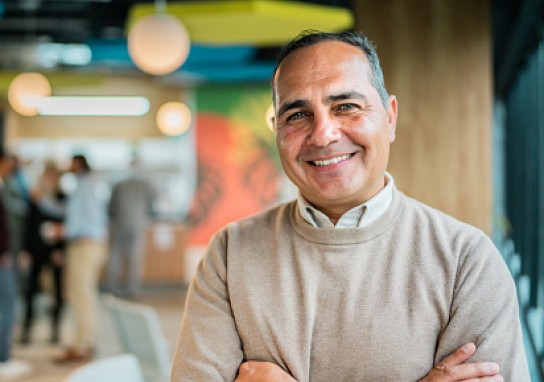 Man smiling in corporate setting