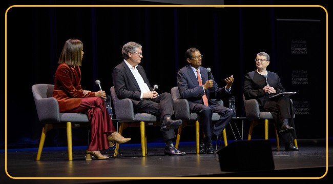 Four panel members seated and engaged in discussion.