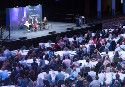 Tech Governance Forum 2025: People sitting and listening to a panel in a large conference room.