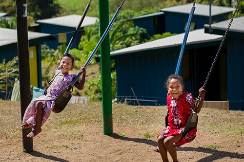 Fijian Village children on swing