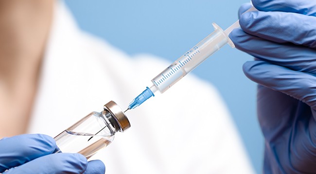Needle in vaccine vial Needle in vaccine vial