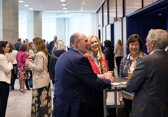 A group of people engaged in conversation at a conference.