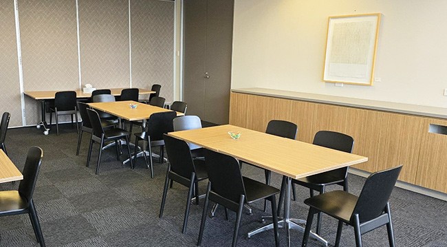 Large breakout space with tables and chairs, featuring power points, connected to the Port Phillip Room, AICD Melbourne Lounge.