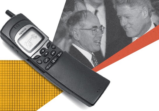 A mobile device featuring pictures of Bill Clinton and John Howard displayed prominently.