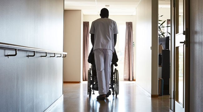 carer pushing wheelchair carer pushing wheelchair