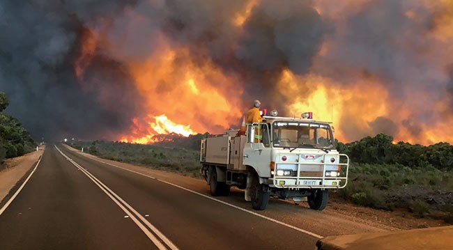 Fire truck near bushfire Fire truck in front of bushfire blaze